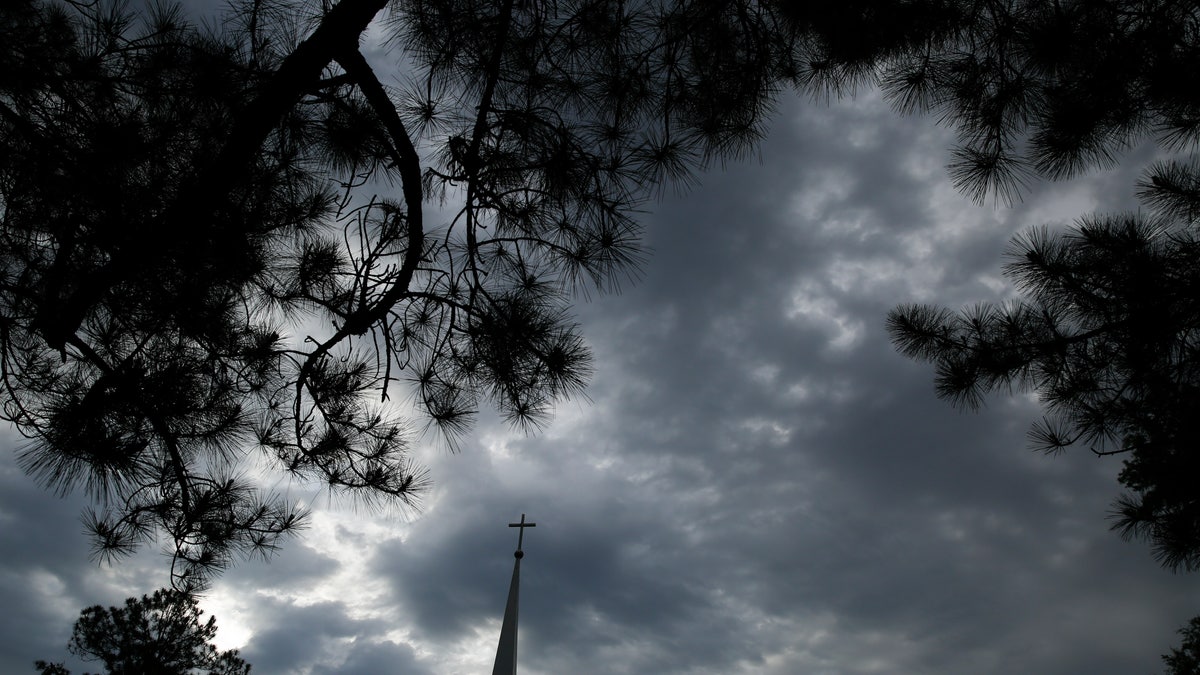 Clouds filling the sky near a church in Dawson, Ga., this past April. (AP Photo/Brynn Anderson, File)
