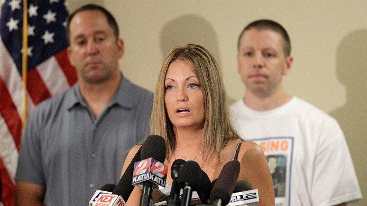 Kyron Horman's birth mother Desiree Young makes remarks during a news conference while Desiree's husband Tony Young, left, and Kaine Horman, Kyron's father, look, at the Multnomah County Sheriff's Training Facility, in Portland, Ore. Kyron Horman went missing from Skyline Elementary School June 4 and the search for him is ongoing Missing Oregon Boy, Portland, USA.