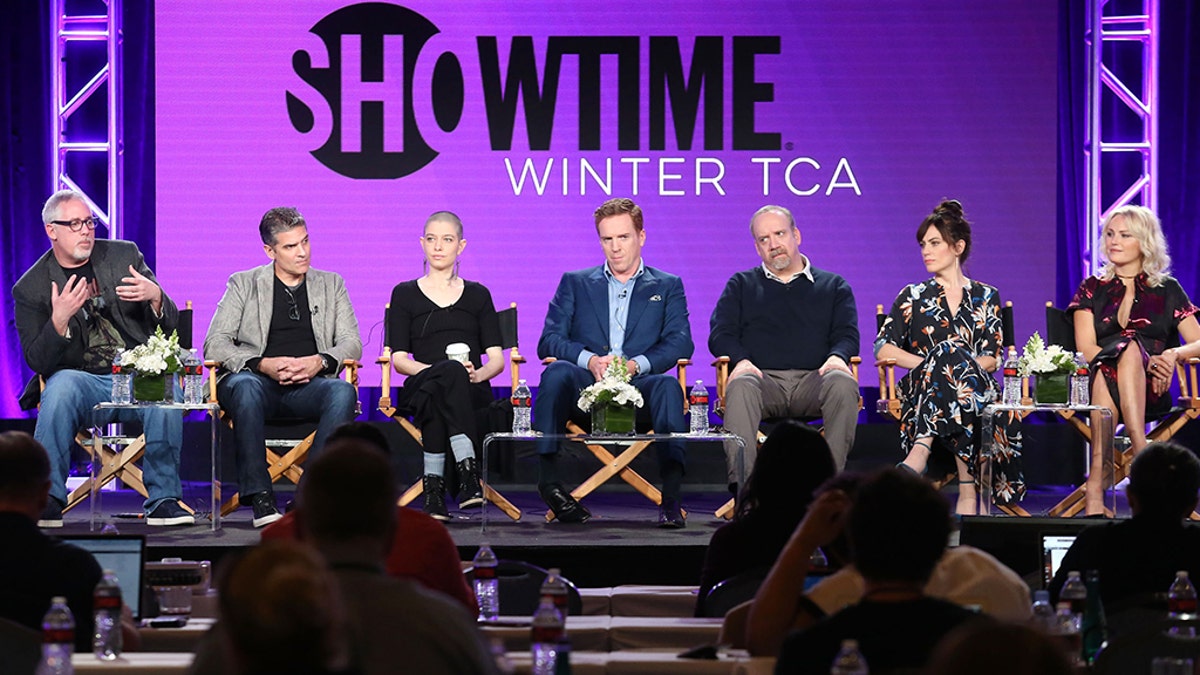 (L-R) Executive producer &amp; creator Brian Koppelman, executive producer creator David Levien, actors Asia Kate Dillon, Damian Lewis, Paul Giamatti, Maggie Siff and Malin Akerman of the television show 'Billions.'