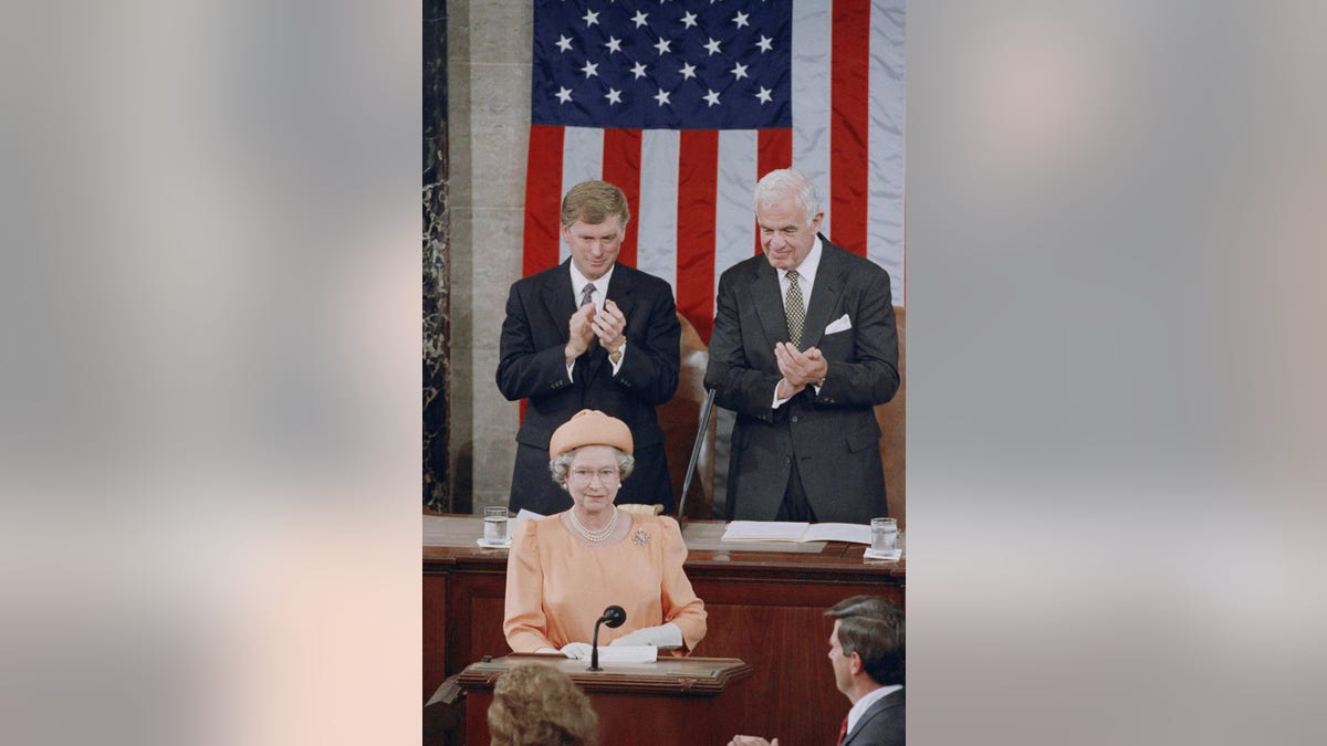 Queen Elizabeth II is applauded by Vice President Dan Quayle and House Speaker Thomas Foley before her address to the U.S. Congress on Thursday, May 16, 1991 in Washington. (AP Photo/Doug Mills)