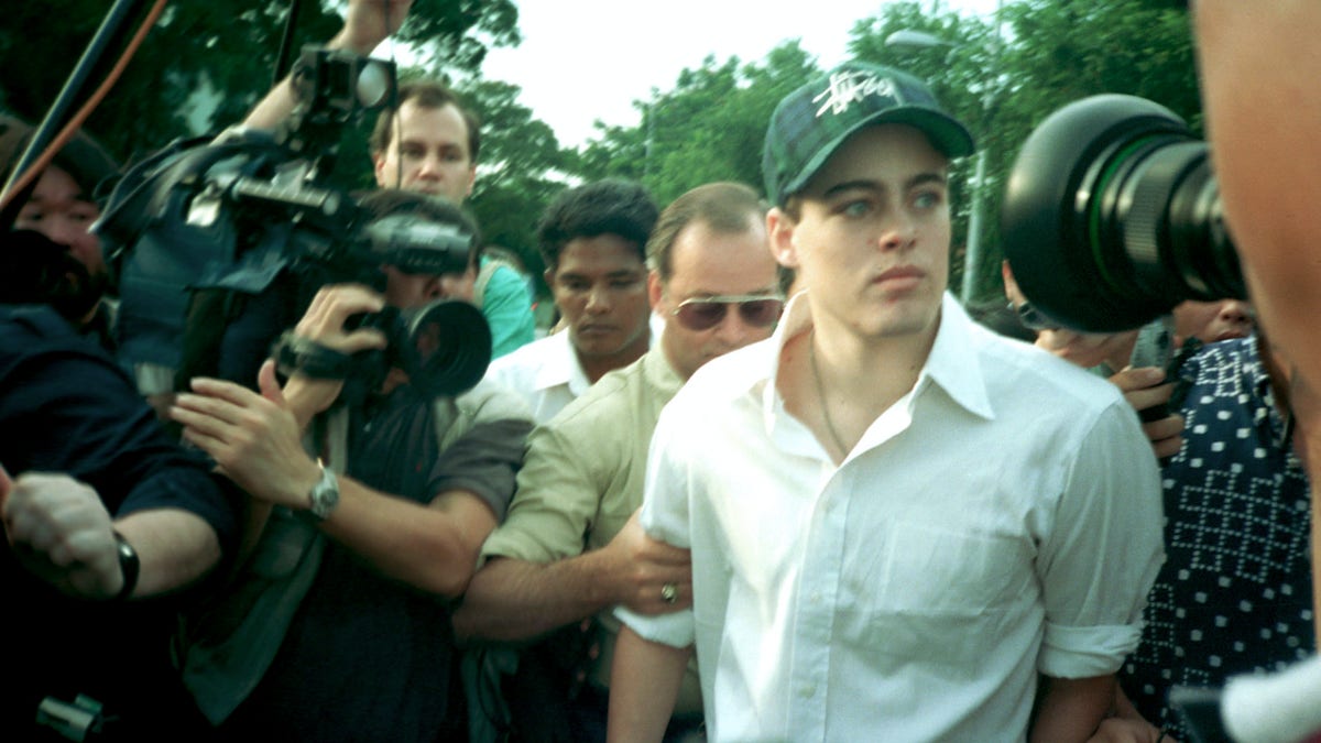 American Michael Fay, 19, accompanied by his father George, behind, leaving the Queenstown Prison in Singapore following his release. (AP Photo/Tan Ah Soon, File)