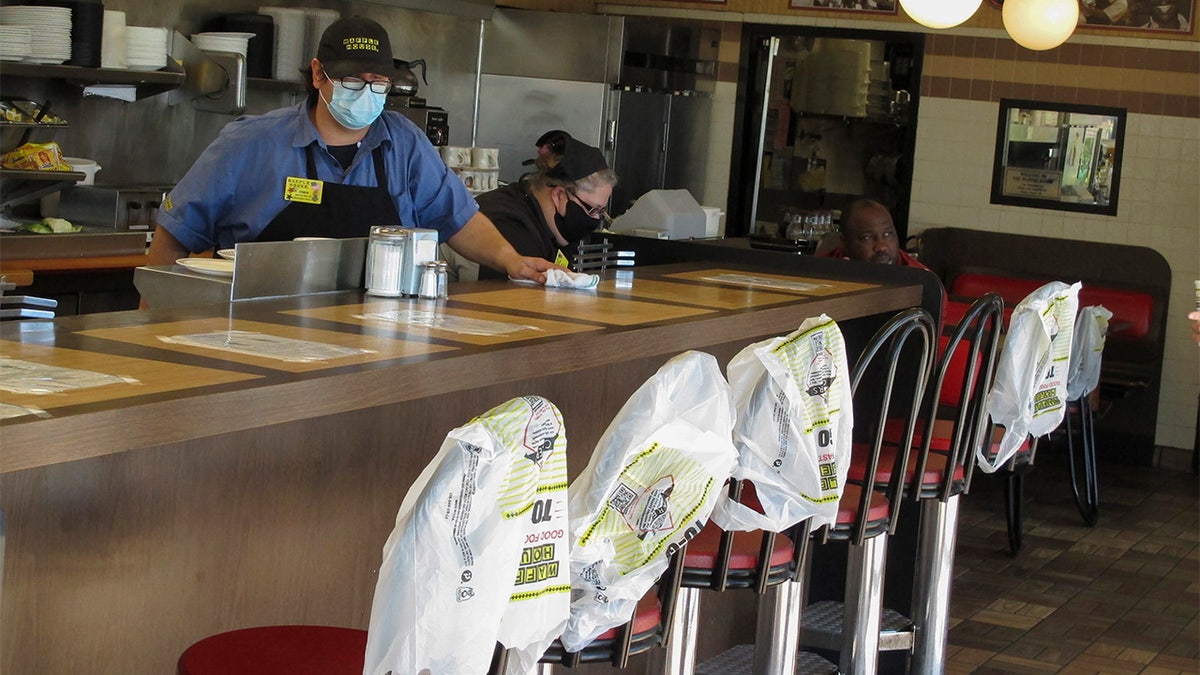 Plastic bags mark off seats to promote social distancing at a Waffle House restaurant in Savannah, Ga., on Monday, April 27, 2020. Restaurants statewide have been allowed to resume dine-in service with restrictions after a month of being limited to takeout meals only because of the coronavirus.