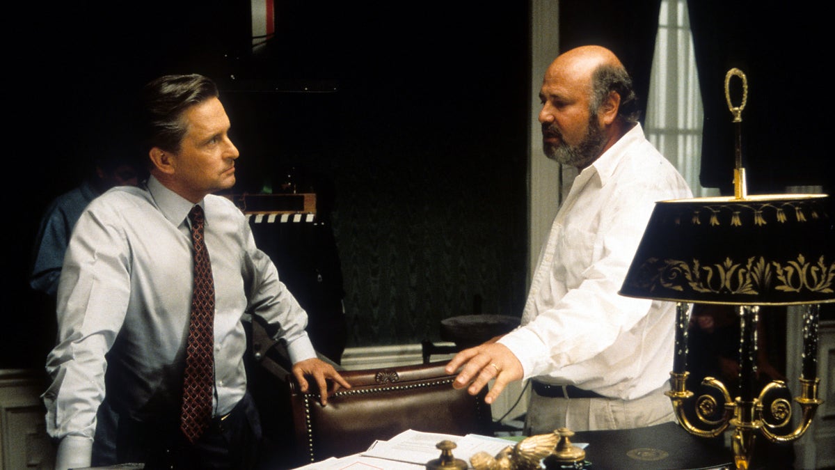 Michael Douglas (L) listening to director Rob Reiner in between scenes from the film 'The American President.'