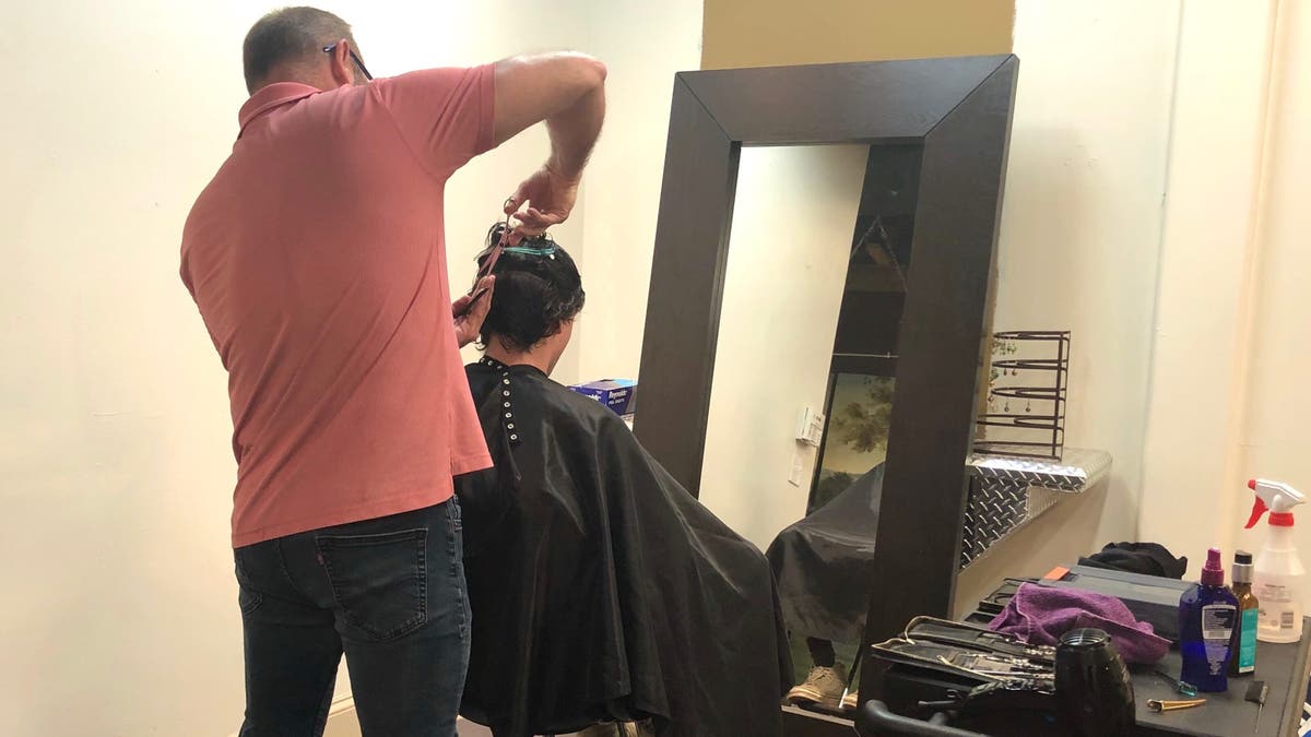 Hairstylist John Bryant reopens his salon and begins taking limited clients.