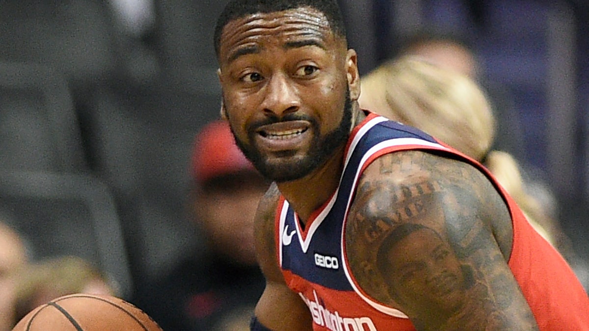 FILE - In this Dec. 1, 2018, file photo, Washington Wizards guard John Wall (2) dribbles the ball during the first half of an NBA basketball game against the Brooklyn Nets in Washington. Wizards point guard John Wall says he is "110%" healthy after missing the past 1½ years with two major injuries. He is working out at home and looking forward to getting back to the NBA next season.