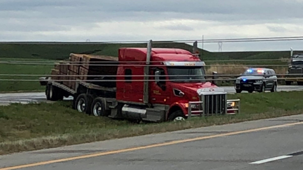 A semi-truck nearly hit power lines that were knocked down by a severe thunderstorm in Kansas on Monday.