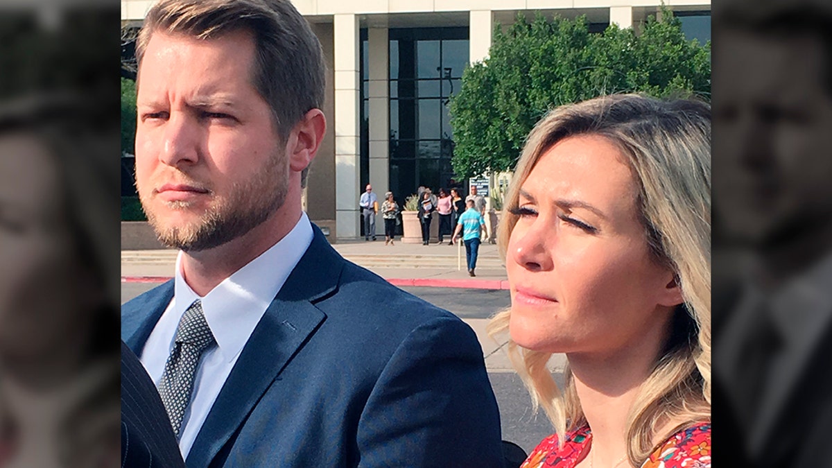 In this Feb. 27, 2020 photo Melani Pawlowski, right, is shown with her husband Ian Pawlowski outside a courthouse in Mesa, Ariz. Her ex-husband has alleged Pawlowski knows the whereabouts of two of her aunt Lori Vallow's two children, who have been missing since September. Pawlowski's lawyers denied the allegation and said their client has cooperated with authorities in the investigation. (AP Photo/Jacques Billeaud)