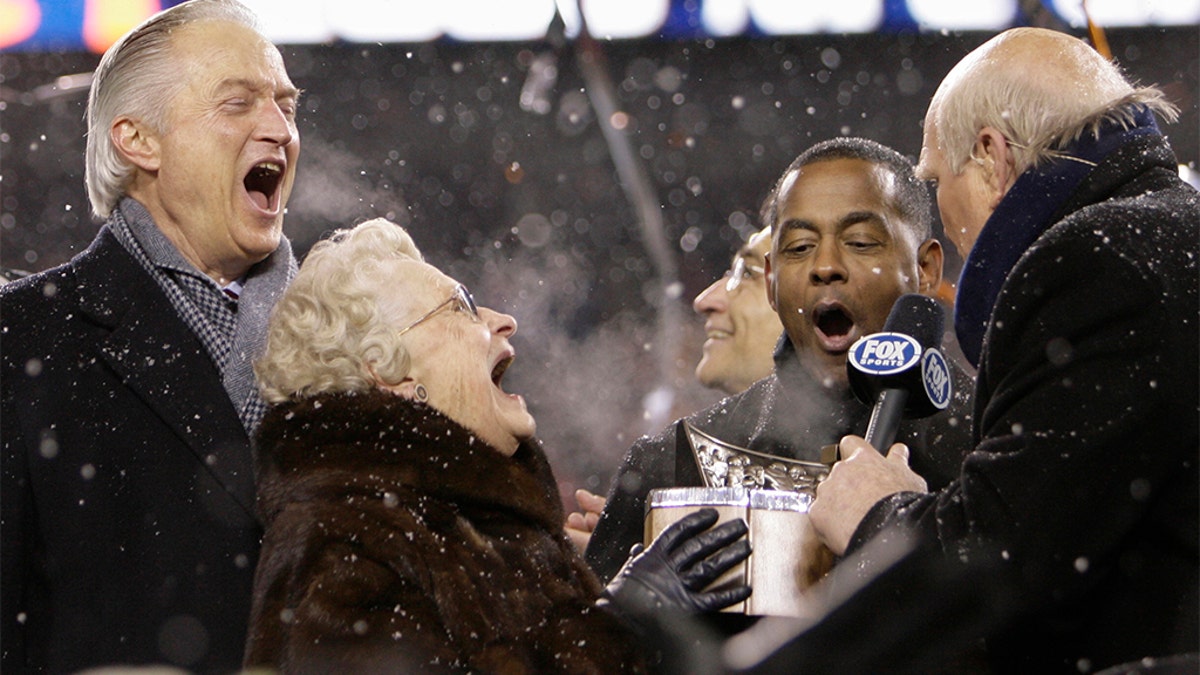 FILE - In this Jan. 21, 2007, file photo, Chicago Bears owner Virginia McCaskey and Chairman of the Board Michael McCaskey, left, react as they are presented with the George S. Halas Trophy after the Bears' 39-14 NFL football win over the New Orleans Saints to win the NFC championship football game, in Chicago. Making the presentation are Fox broadcasters Tony Dorsett and Terry Bradshaw, right. (AP Photo/Alex Brandon, File)