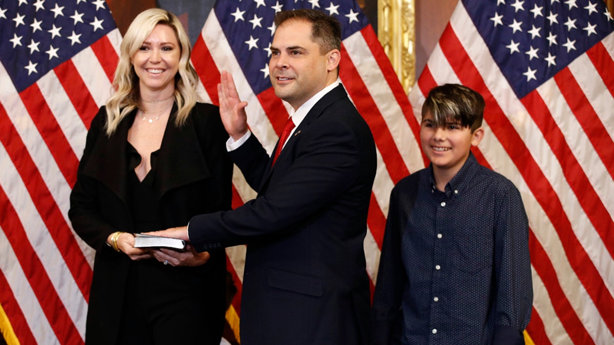Rep. Mike Garcia, R-Calif., joined by his wife Rebecca and son Preston, participates in a ceremonial swearing-in on Capitol Hill in Washington, D.C., Tuesday, May 19, 2020. (AP Photo/Patrick Semansky)