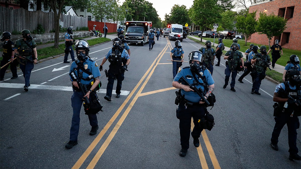 Police officers clear a section of Hamline Avenue in riot gear, Thursday, May 28, 2020, in St. Paul, Minn. (AP Photo/John Minchillo)