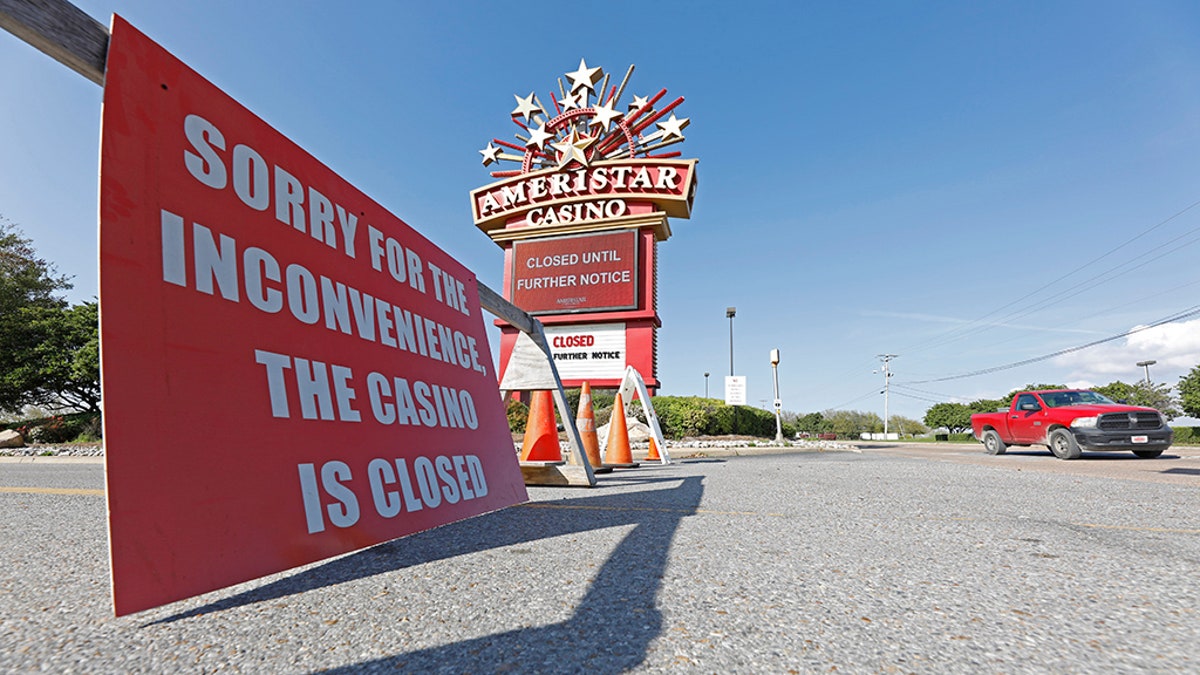 Traffic passes the closed Ameristar Casino in Vicksburg, Miss., Tuesday, March 17, 2020. All of Mississippi's state-regulated casinos were ordered closed by midnight Monday to limit the spread of the new coronavirus. (AP Photo/Rogelio V. Solis)