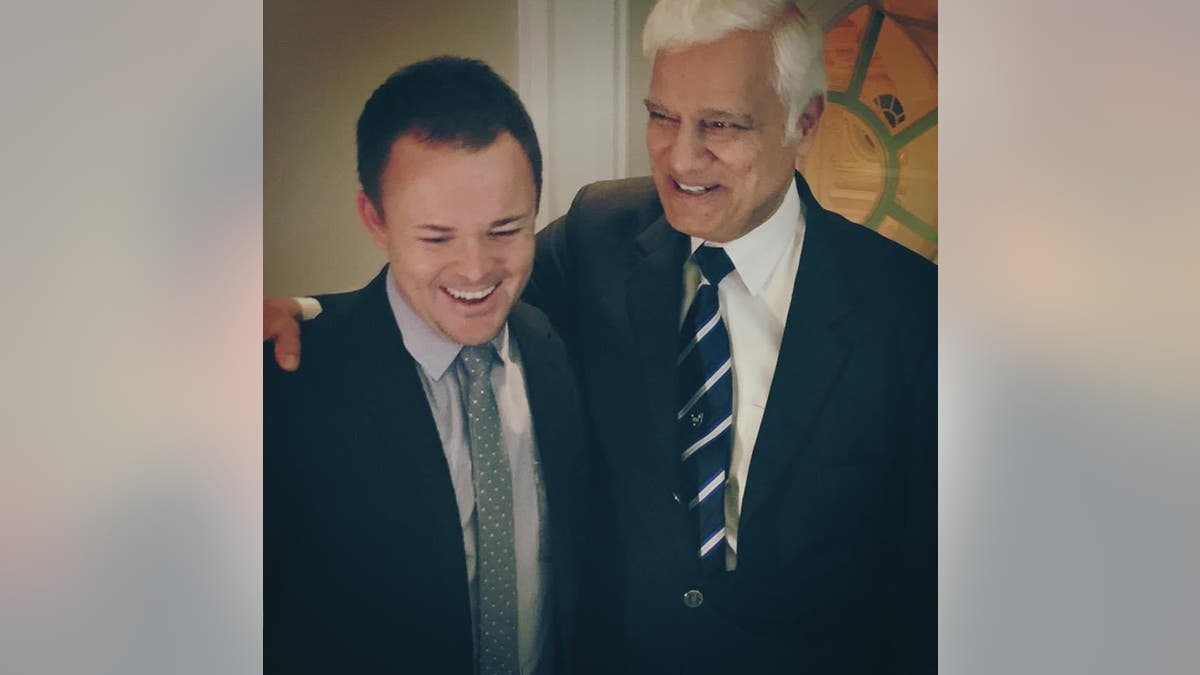 Christian leaders Nick Hall and Ravi Zacharias laugh together.