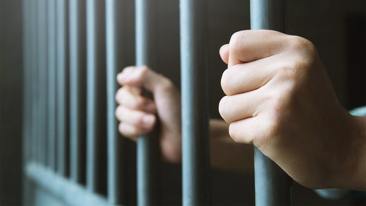 Man in prison bars cell