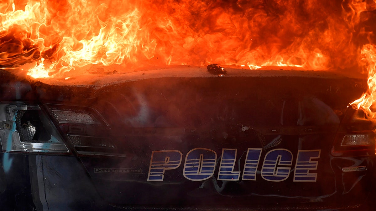 An Atlanta Police Department vehicle burns during a demonstration against police violence, Friday, May 29, 2020 in Atlanta. The protest started peacefully earlier in the day before demonstrators clashed with police. (AP Photo/Mike Stewart)