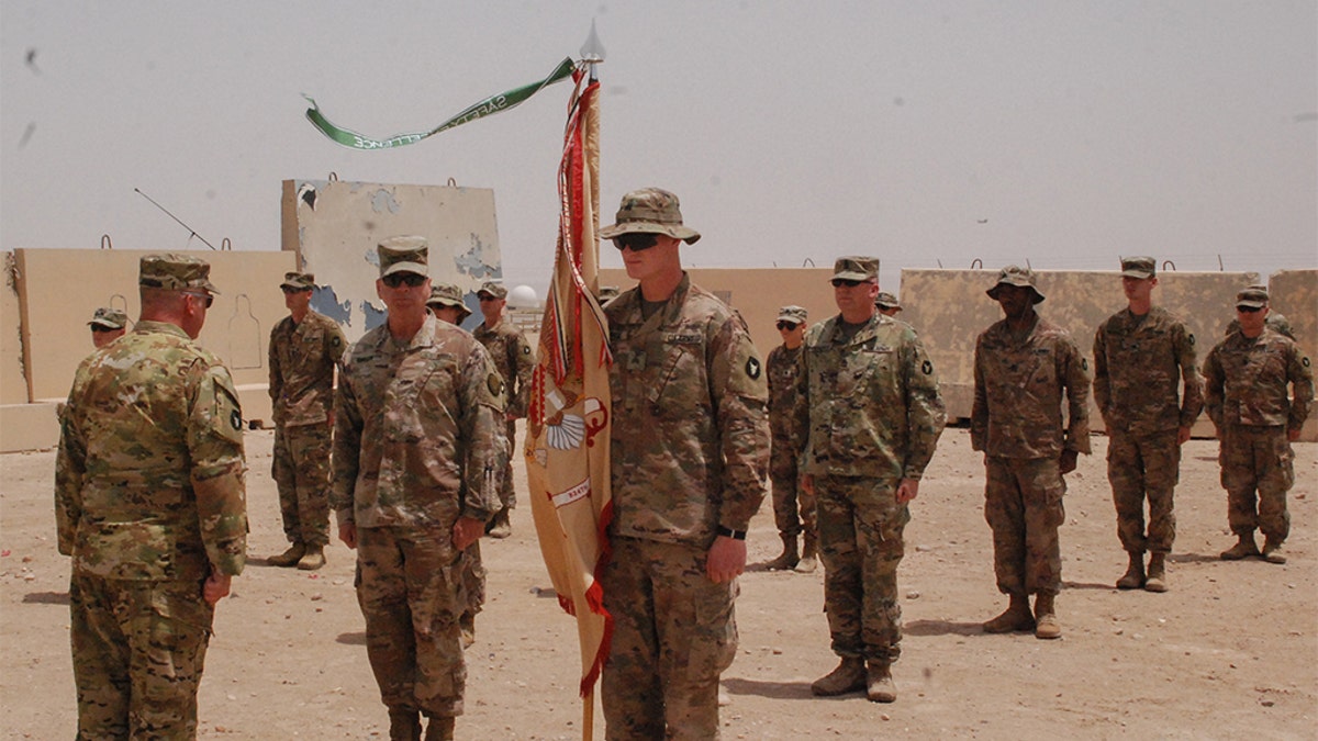 Members of the Headquarters Support Company, 834th Aviation Support Battalion stand in formation (maintaining physical distancing standards for COVID-19 prevention) on May 2, 2020, at Camp Buehring, Kuwait, during the Purple Heart presentation ceremony for Maj. Alan Johnson. (U.S. Army photo by Sgt. Morgan Maidl)