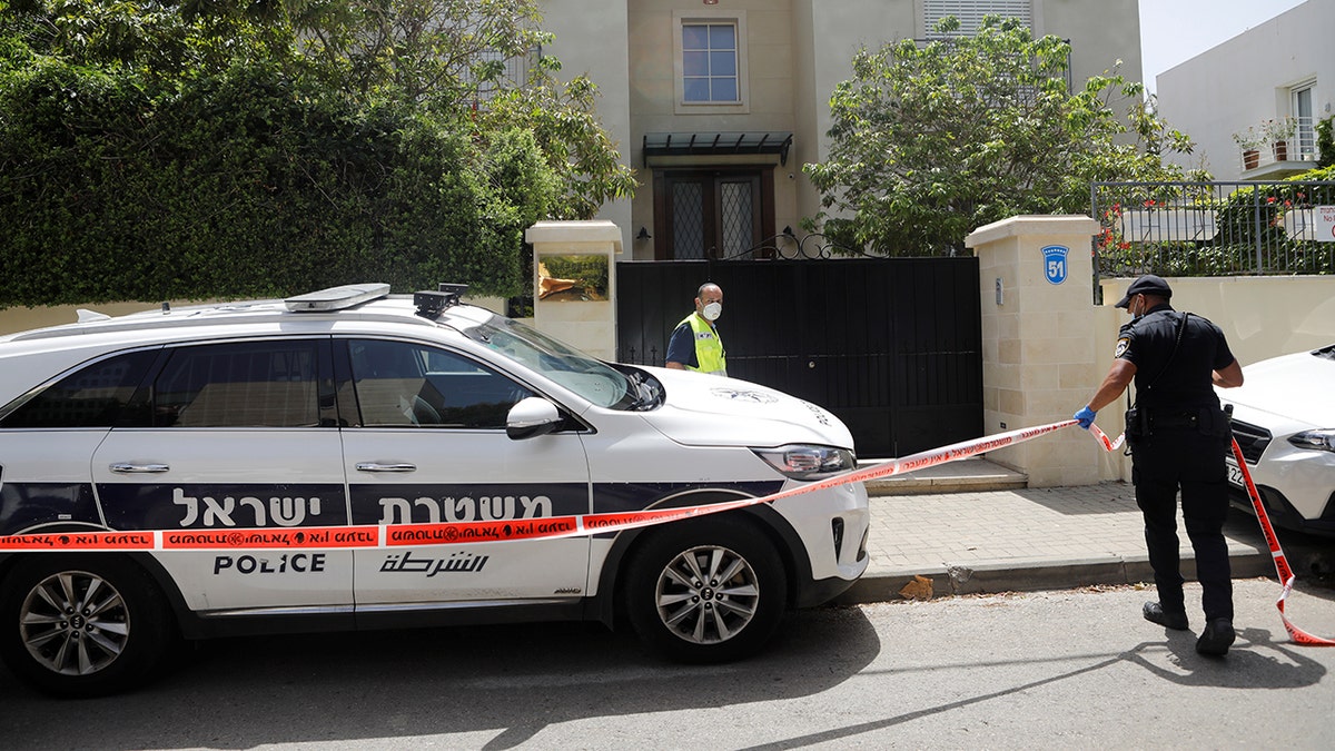 An Israeli policeman cordons off an area near the house of China's ambassador to Israel, Du Wei, in Herzliya, north of Tel Aviv, on Sunday. REUTERS/Nir Elias - RC28QG94RYQO