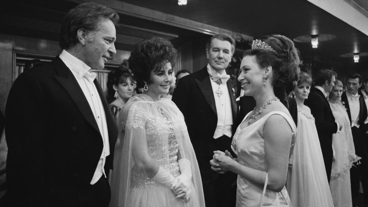 Princess Margaret (1930 - 2002, right) chatting with Richard Burton (1925 - 1984) and his wife Elizabeth Taylor (1932 - 2011). 