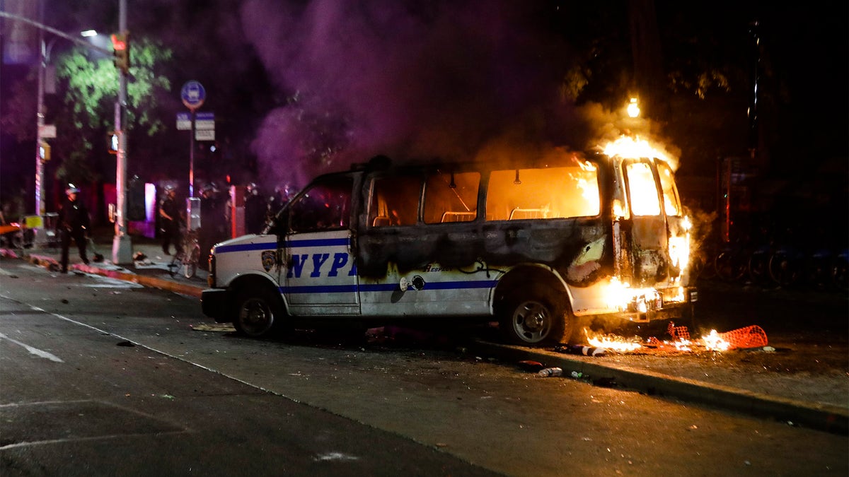 A Police vehicle burns after protesters rallied at Barclays Center over the death of George Floyd, a black man who died Memorial Day while in Minneapolis police custody, Friday, May 29, 2020, in the Brooklyn borough of New York. (AP Photo/Frank Franklin II)