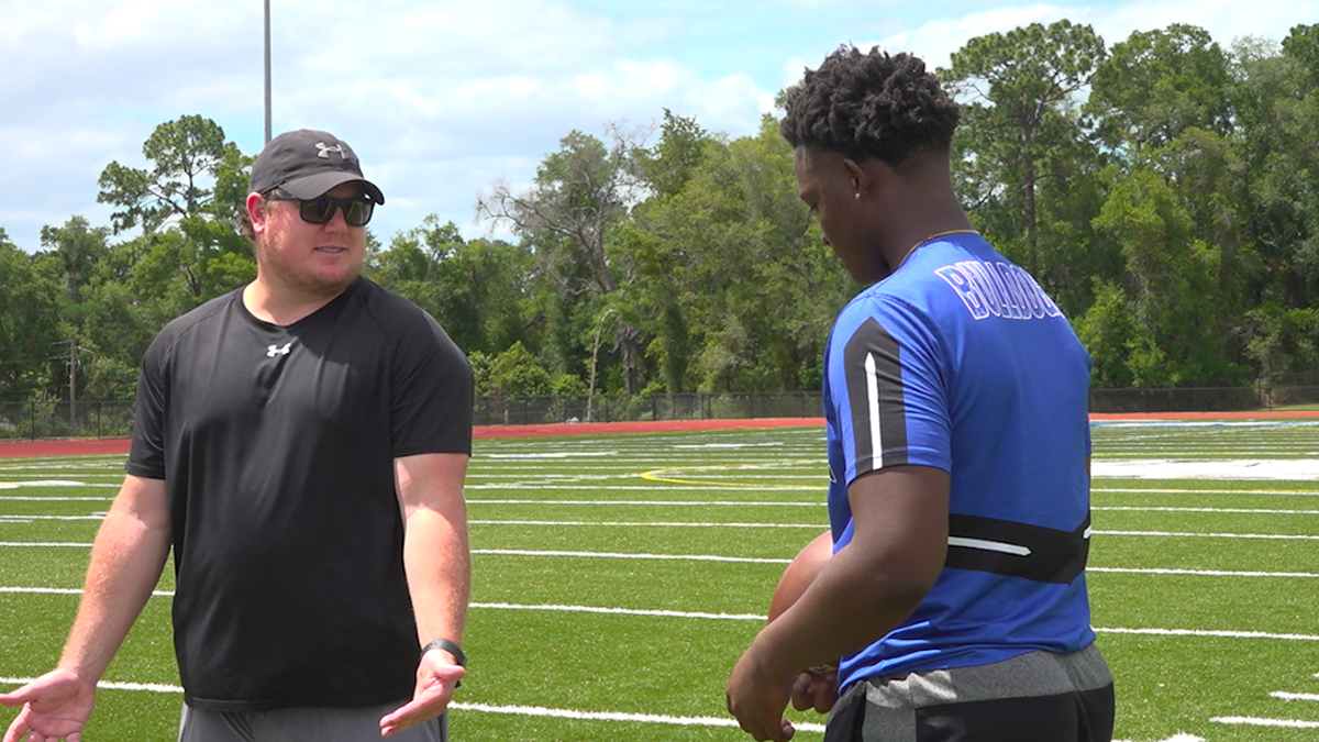 Kolby Tackett (left), Head Football Coach at Mount Dora Christian Academy, speaks with his quarterback, Tyquan Wiggins (Robert Sherman, Fox News)