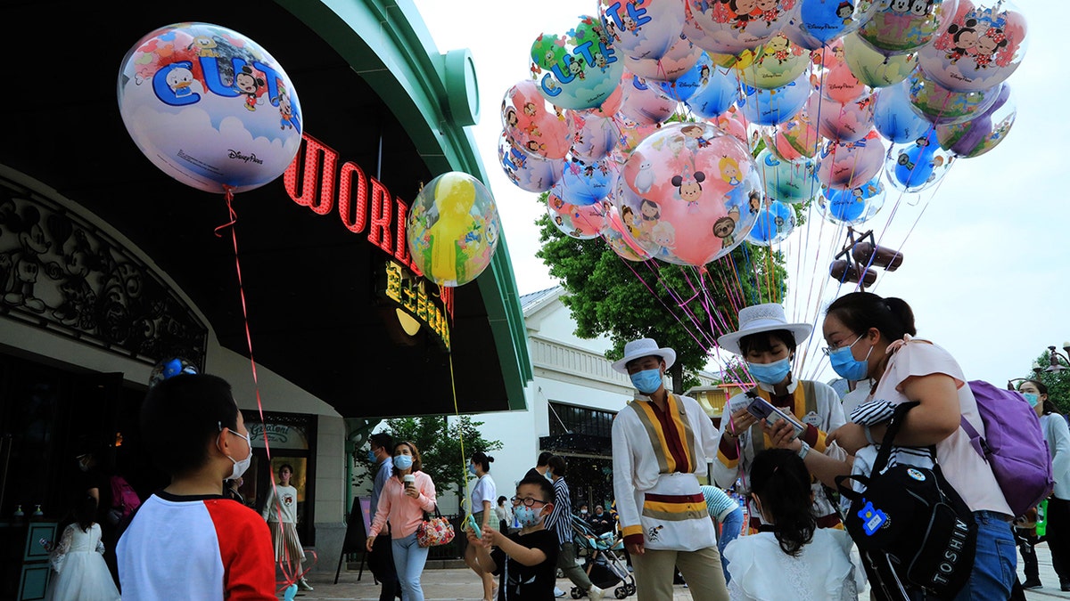 Visitors are seen on May 1 at Shanghai Disney Resort's Disneytown shopping and dining district, which previously opened to guests in March.