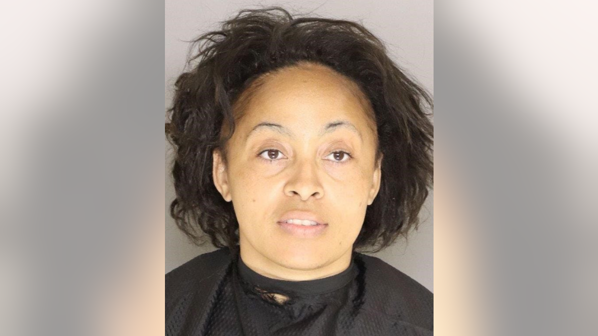 Shenir Gibson Holliday, 38, was taken into custody after police reviewed video footage inside a supermarket that showed her licking her hands and coughing before pulling on freezer doors and touching food items.