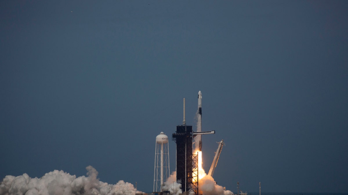 The SpaceX Falcon 9 rocket launches into space from Kennedy Space Center with NASA astronauts Bob Behnken and Doug Hurley aboard the Crew Dragon spacecraft on May 30, 2020.