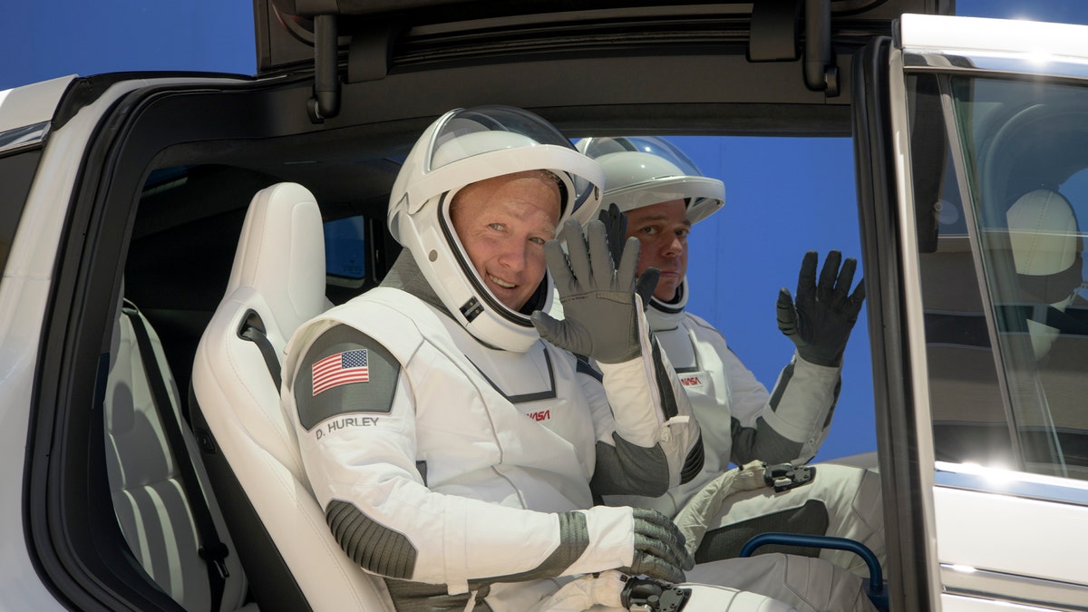 NASA astronauts Douglas Hurley, left, and Robert Behnken, wearing SpaceX spacesuits, depart the Neil A. Armstrong Operations and Checkout Building for Launch Complex 39A during a dress rehearsal prior to the Demo-2 mission launch, Saturday, May 23, 2020, at NASA's Kennedy Space Center in Cape Canaveral, Fla.