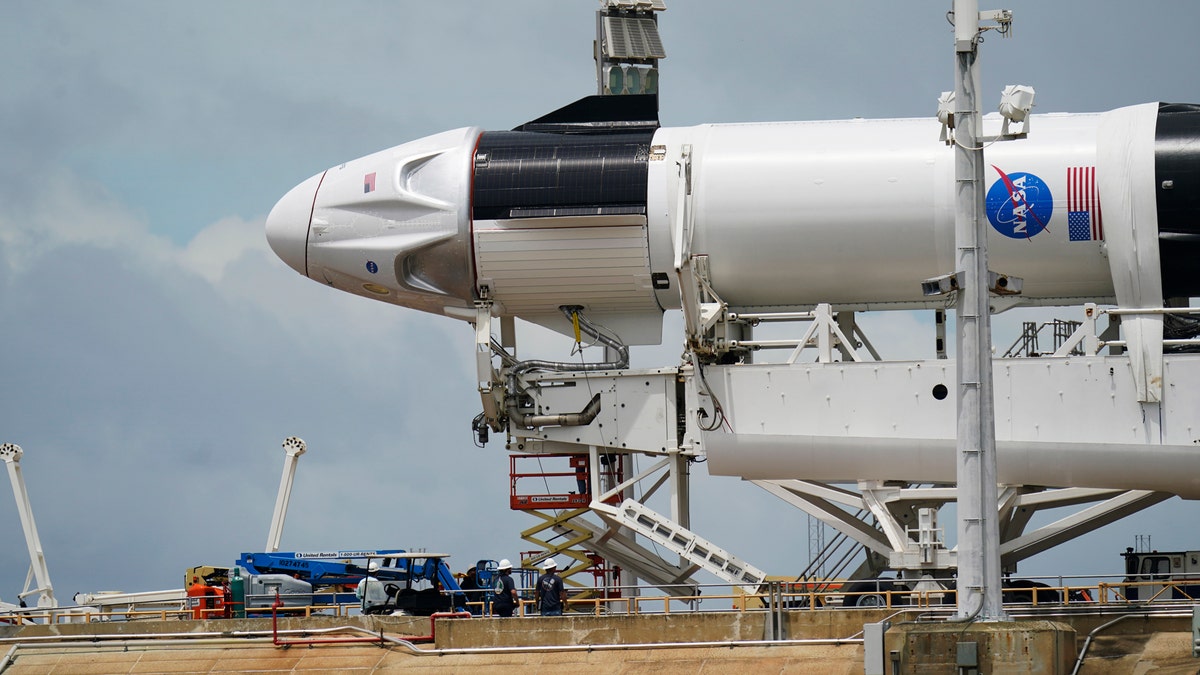 The SpaceX Falcon 9, with Dragon crew capsule is serviced on Launch Pad 39-A Tuesday, May 26, 2020, at the Kennedy Space Center in Cape Canaveral, Fla. Two astronauts will fly on the SpaceX Demo-2 mission to the International Space Station scheduled for launch on May 27. (Associated Press)