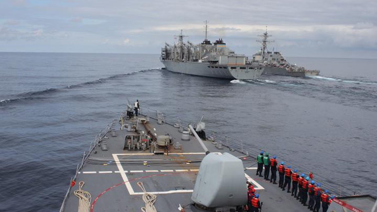 The Arleigh Burke-class guided-missile destroyer USS Donald Cook makes her approach alongside USNS SUPPLY and USS Porter for a connected replenishment to receive fuel and stores on April 28. (Photo by Yeoman Third Class Anthony Nichols)