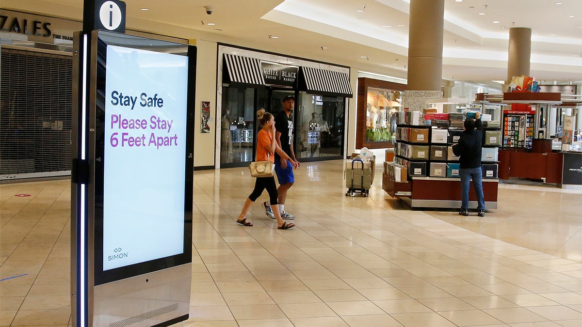 Signage encourages social distancing as Penn Square Mall reopens to the public Friday, May 1, 2020, in Oklahoma City. The mall has been closed since mid-March due to coronavirus concerns. 