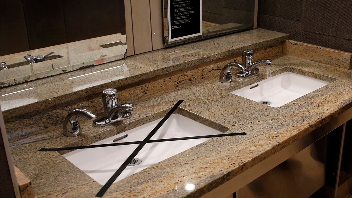 Alternating sinks in the restroom at Penn Square mall are taped off to promote social distancing as the mall reopens Friday, May 1, 2020, in Oklahoma City. The mall has closed one of two restrooms and five of seven entrances. The mall has been closed since mid-March due to coronavirus concerns.