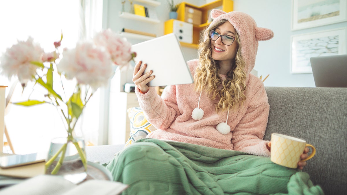 Young woman sits at home