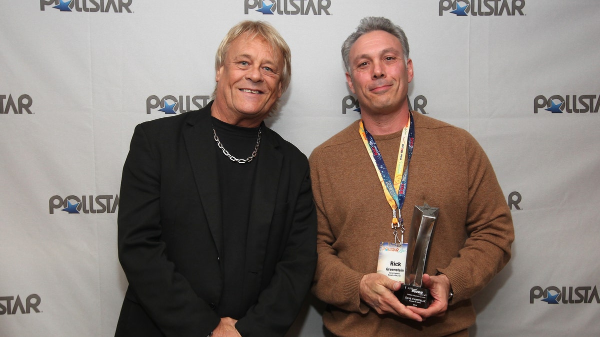 Bad Company's Briane Howe and Comedy Tour of the Year Award recipient Rick Greenstein pose backstage during the 26th Annual PollStar Awards at Ryman Auditorium on Feb. 21, 2015 in Nashville, Tenn.