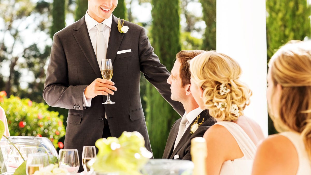 Best Man Looking At Couple While Giving Speech During Reception