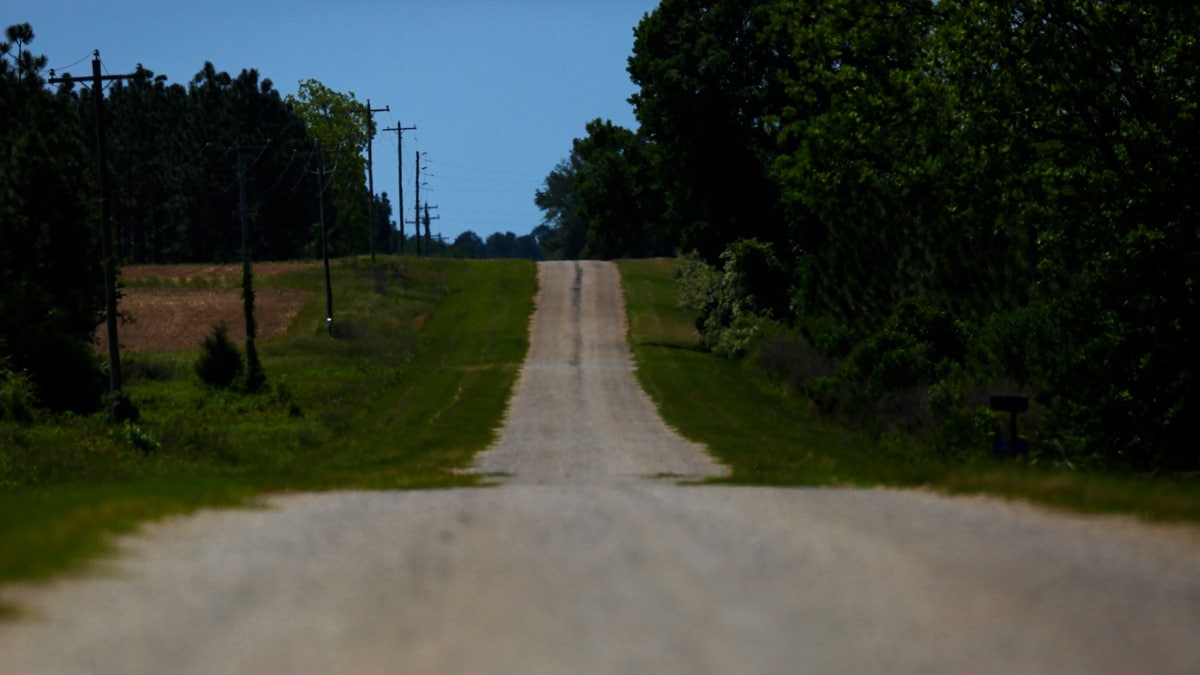 An empty road leading towards a rural countryside of Dawson, Ga., this past April. (AP Photo/Brynn Anderson, File)
