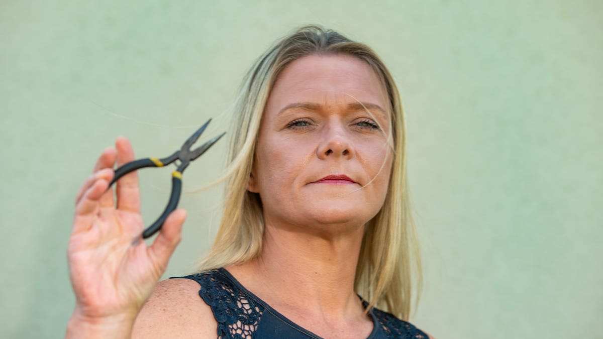 Fay Rayward with the pliers that she tried to use to remove her tooth at her home.