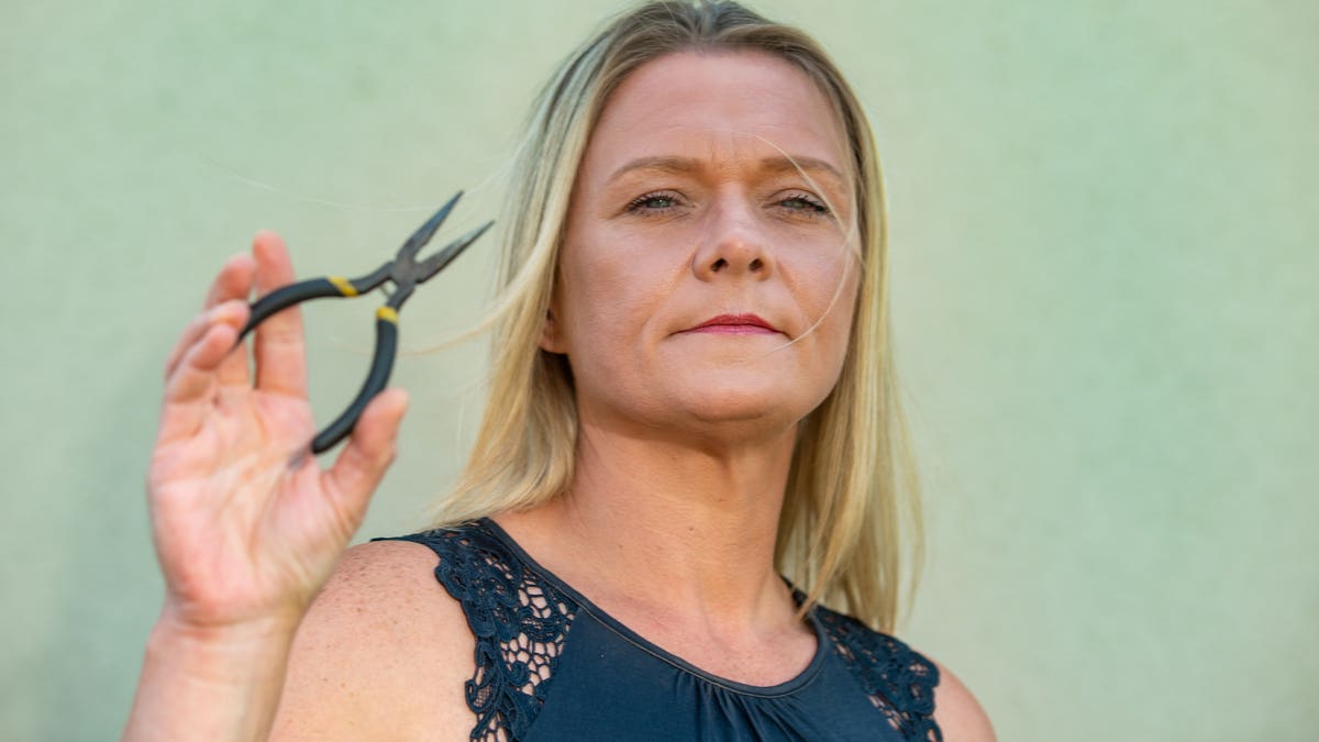 Fay Rayward with the pliers that she tried to use to remove her tooth at her home.