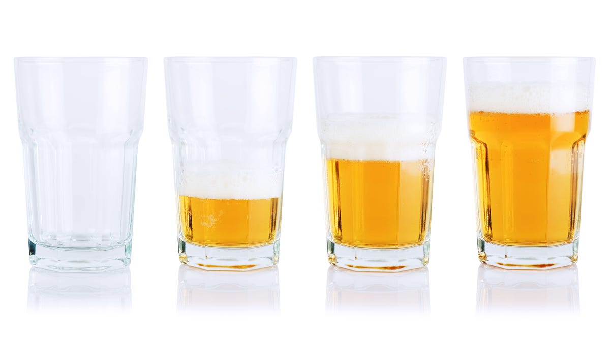 Different stages of beer consumption in five mugs