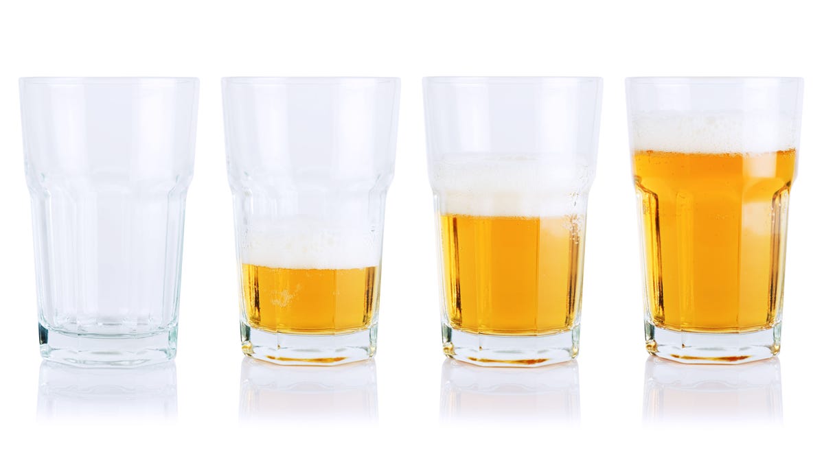 Different stages of beer consumption in five mugs