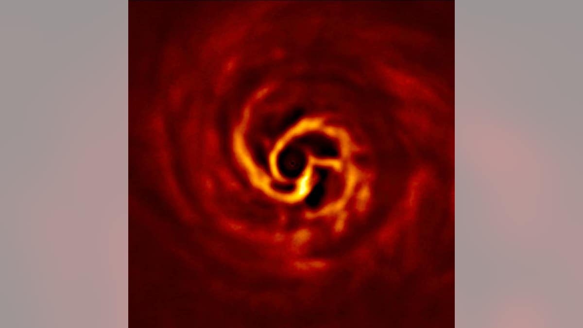 This image shows the inner region of the disc around the young AB Aurigae star, where ESO’s Very Large Telescope has spotted signs of planet birth.