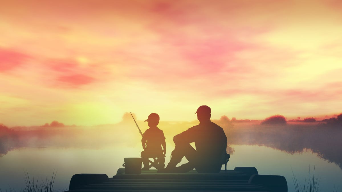 Father with son in the morning fishing from a wooden pier