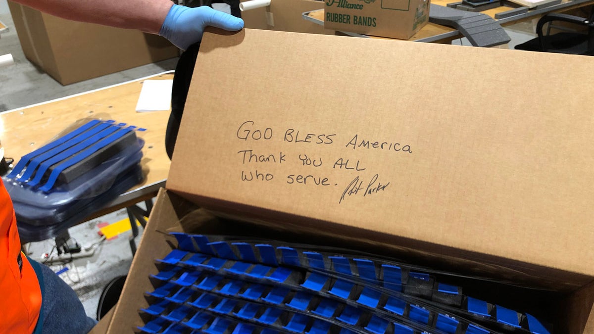 Ford Motor Co. worker leaves a message to the military who will receive their face shields. (Ford Motor Co. photo)
