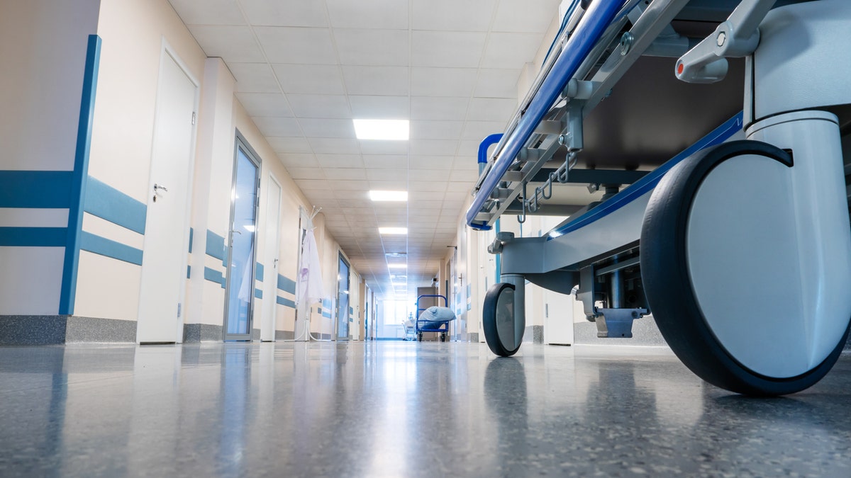 Medical bed on wheels in a hospital corridor. View from below.