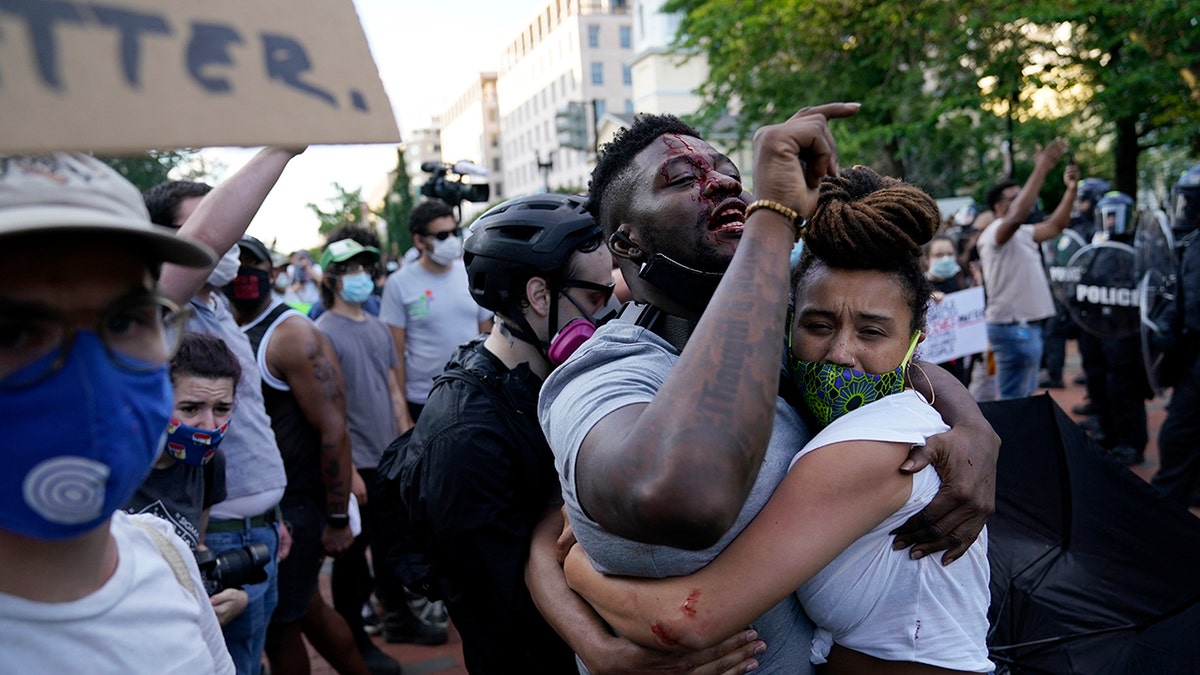 A demonstrator is injured as people protest the death of George Floyd, Saturday, May 30, 2020, near the White House in Washington. Floyd died after being restrained by Minneapolis police officers. (Associated Press)