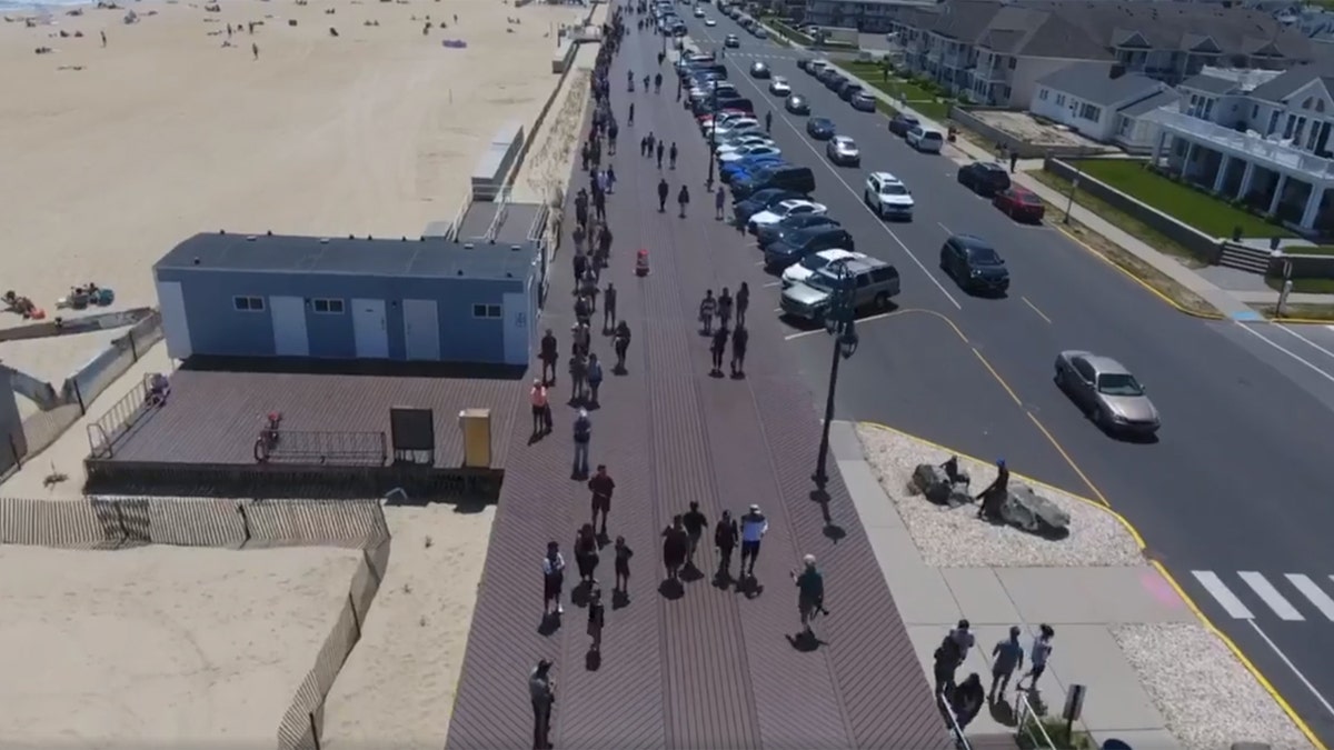 Hundreds of people line up to purchase seasonal beach badges in Belmar, N.J. on Saturday, May 16, 2020.