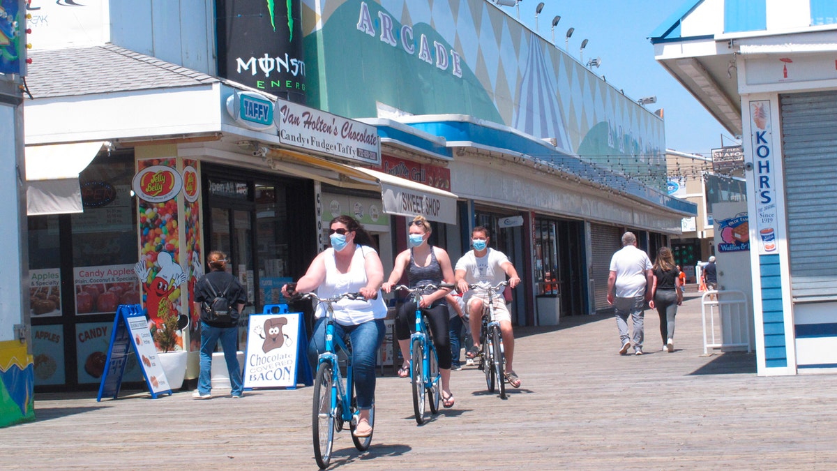 Bicyclists ride on the boardwalk in Seaside Heights, N.J. on May 15, 2020, the on the first day it opened during the coronavirus outbreak.