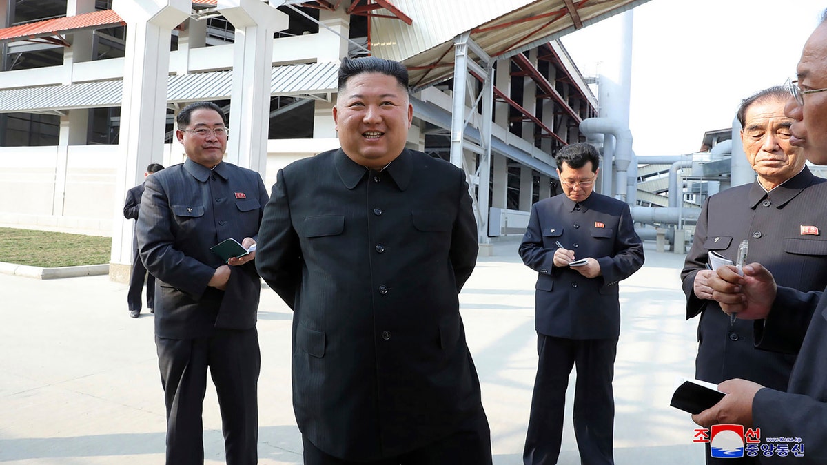 In this Friday, May 1, 2020, photo provided by the North Korean government, North Korean leader Kim Jong Un, center, visits a fertilizer factory in Sunchon, South Pyongan province, near Pyongyang, North Korea.