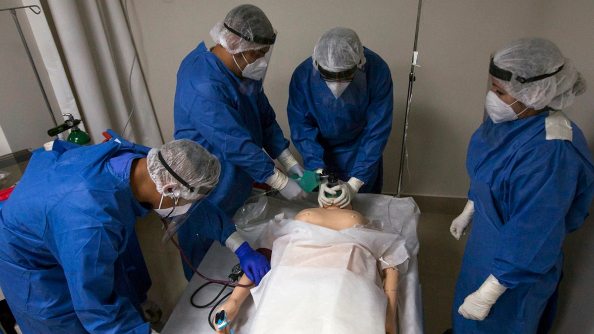 Military doctors and nurses train with a mannequin on the premises of a hospital to receive patients with Covid-19 in Monterrey, Nuevo Leon, Mexico, on May 18, 2020. 