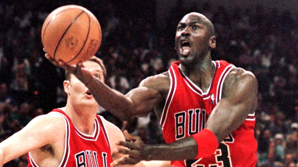 Michael Jordan dribbles past Luc Longley