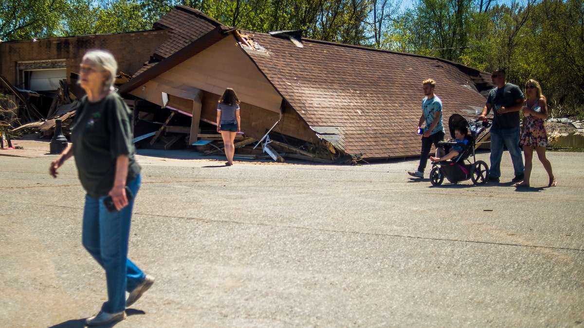 Sanford, Mich., residents survey the destruction in downtown Sanford, May 21. The downtown area was decimated by severe flooding caused by dam failures upstream.